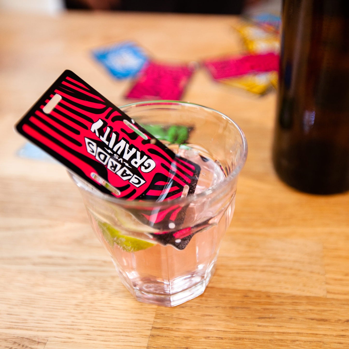 Glass with a red and black card on a wooden table