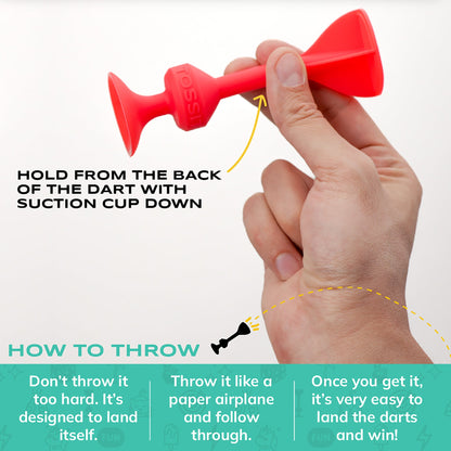 Hand holding a red silicon dart with instructions on how to throw it