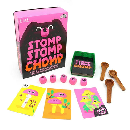 Stomp Stomp Chomp card game components including cards, dice, and wooden spoons on a white background.
