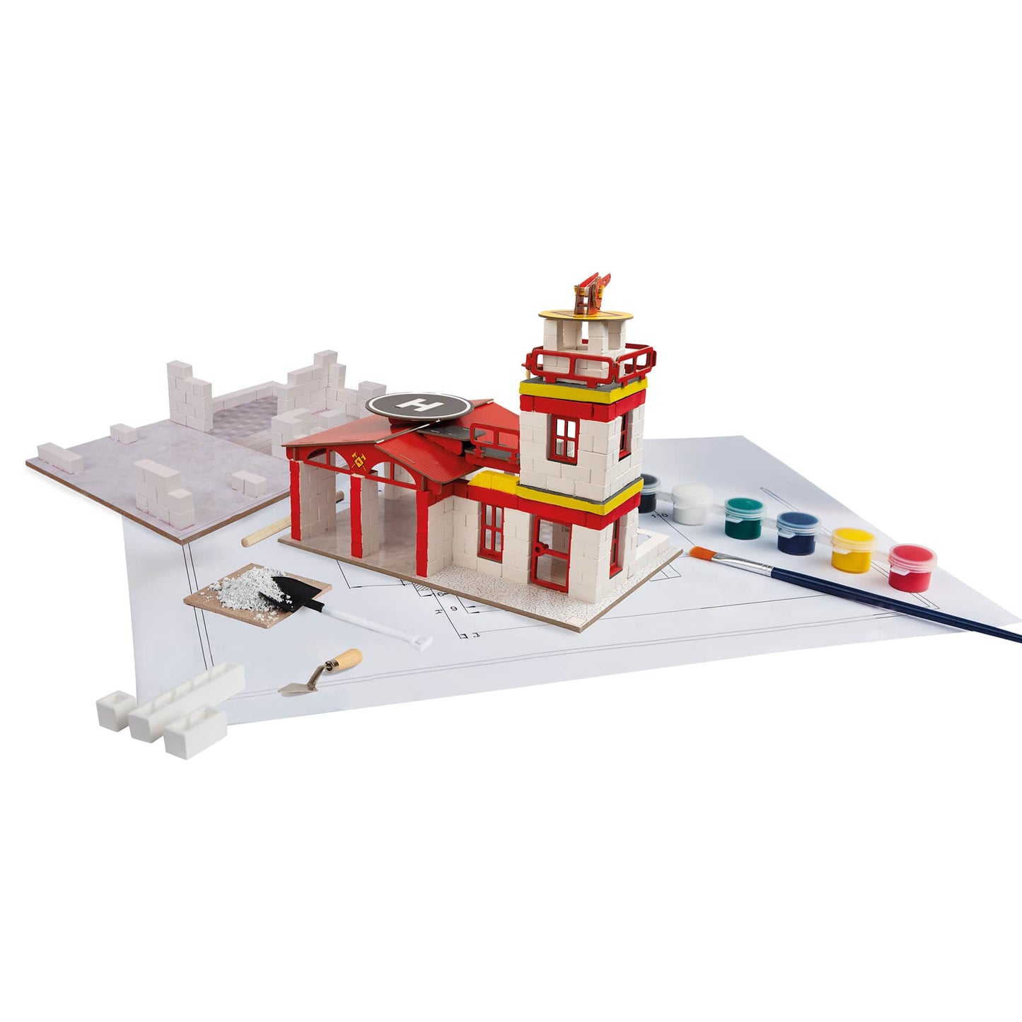 Model of a fire station with tools and paint supplies on a white background