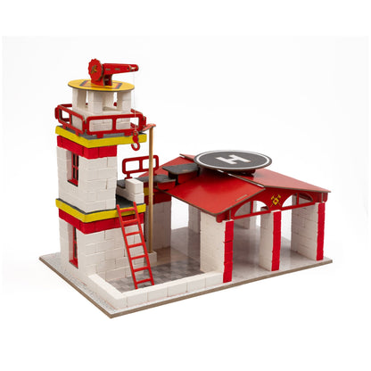 Toy fire station with a ladder and lookout tower on a white background