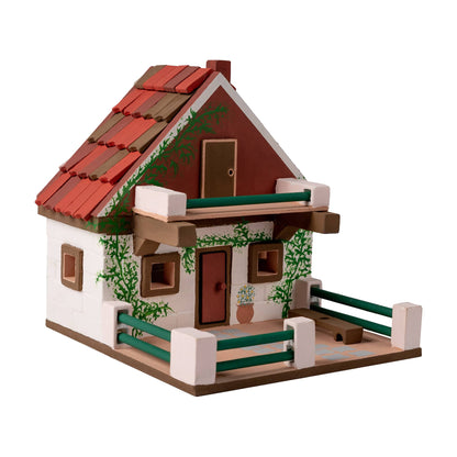 Wooden model of a house with a red roof and white walls on a white background