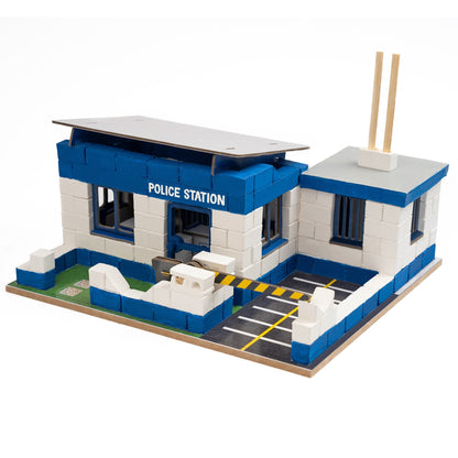 Model of a police station made from interlocking bricks on a white background
